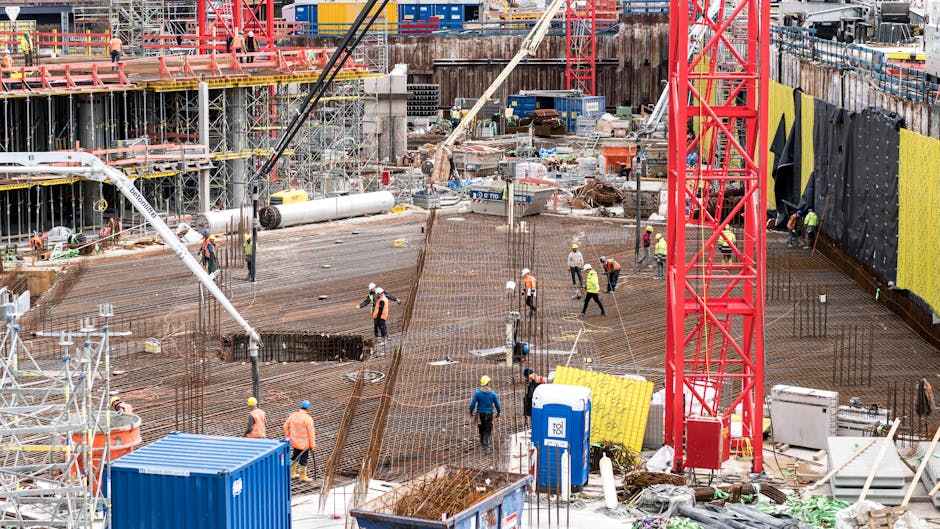 A bustling construction site in Hamburg with workers and equipment.