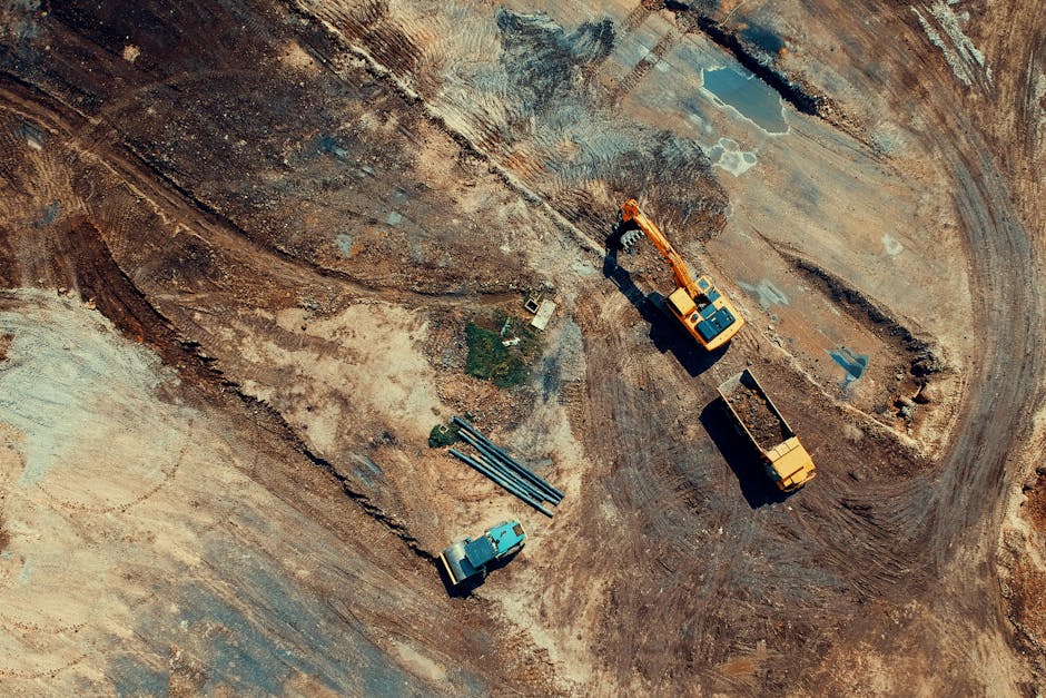 Aerial view of a construction site featuring heavy machinery and trucks.