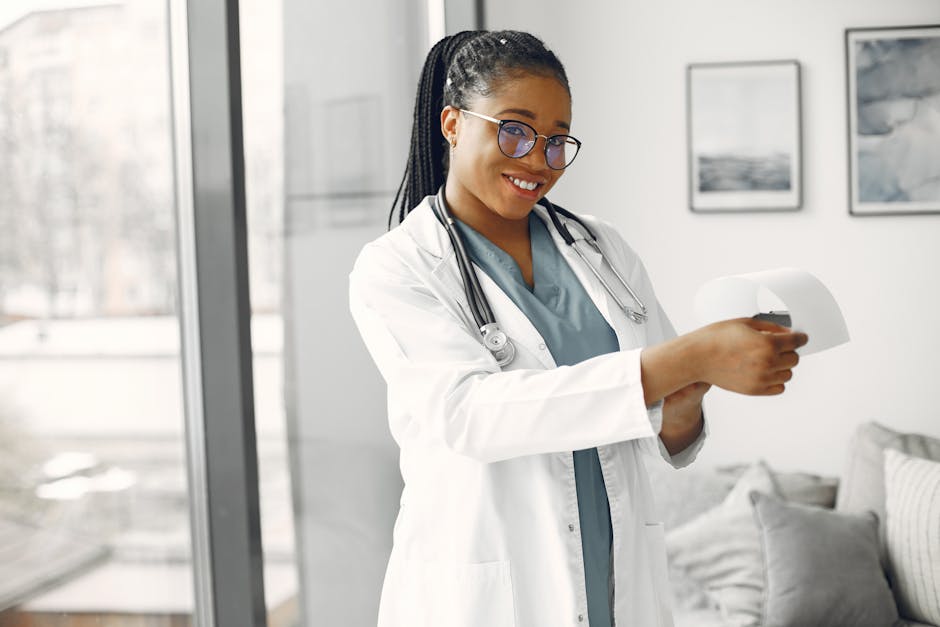 Smiling female doctor in glasses and stethoscope holding a document indoors