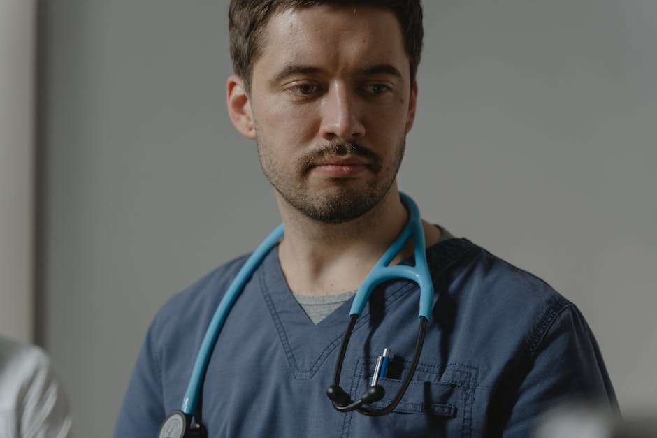 Close-up of a male healthcare worker with stethoscope in a clinical setting