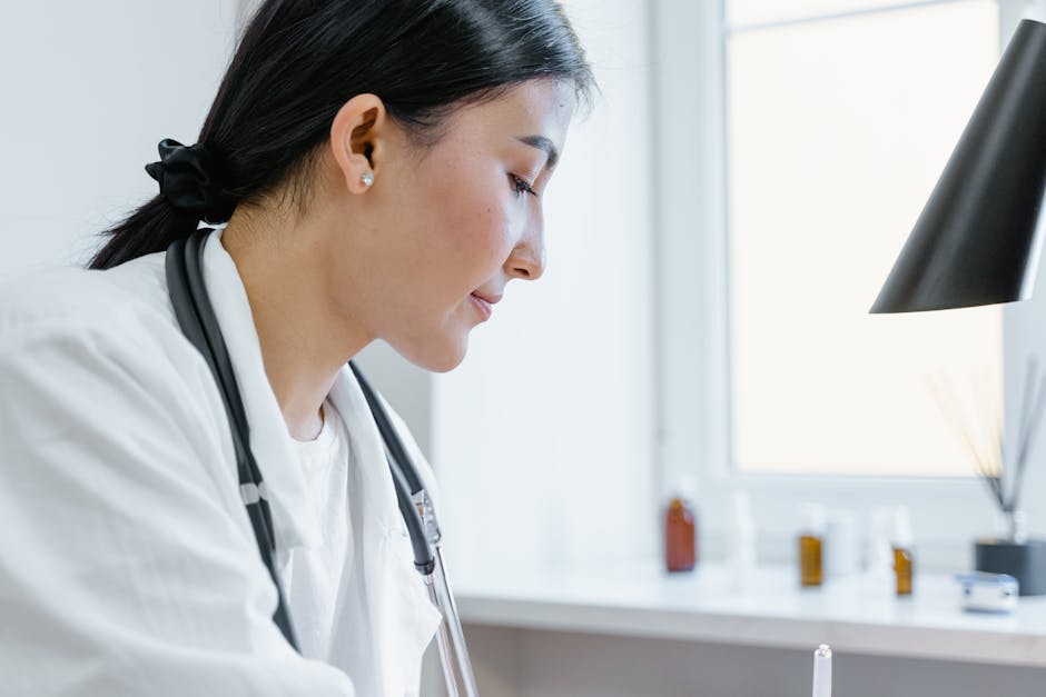 Close-up of an Asian female doctor working in an office setting, with medical tools visible